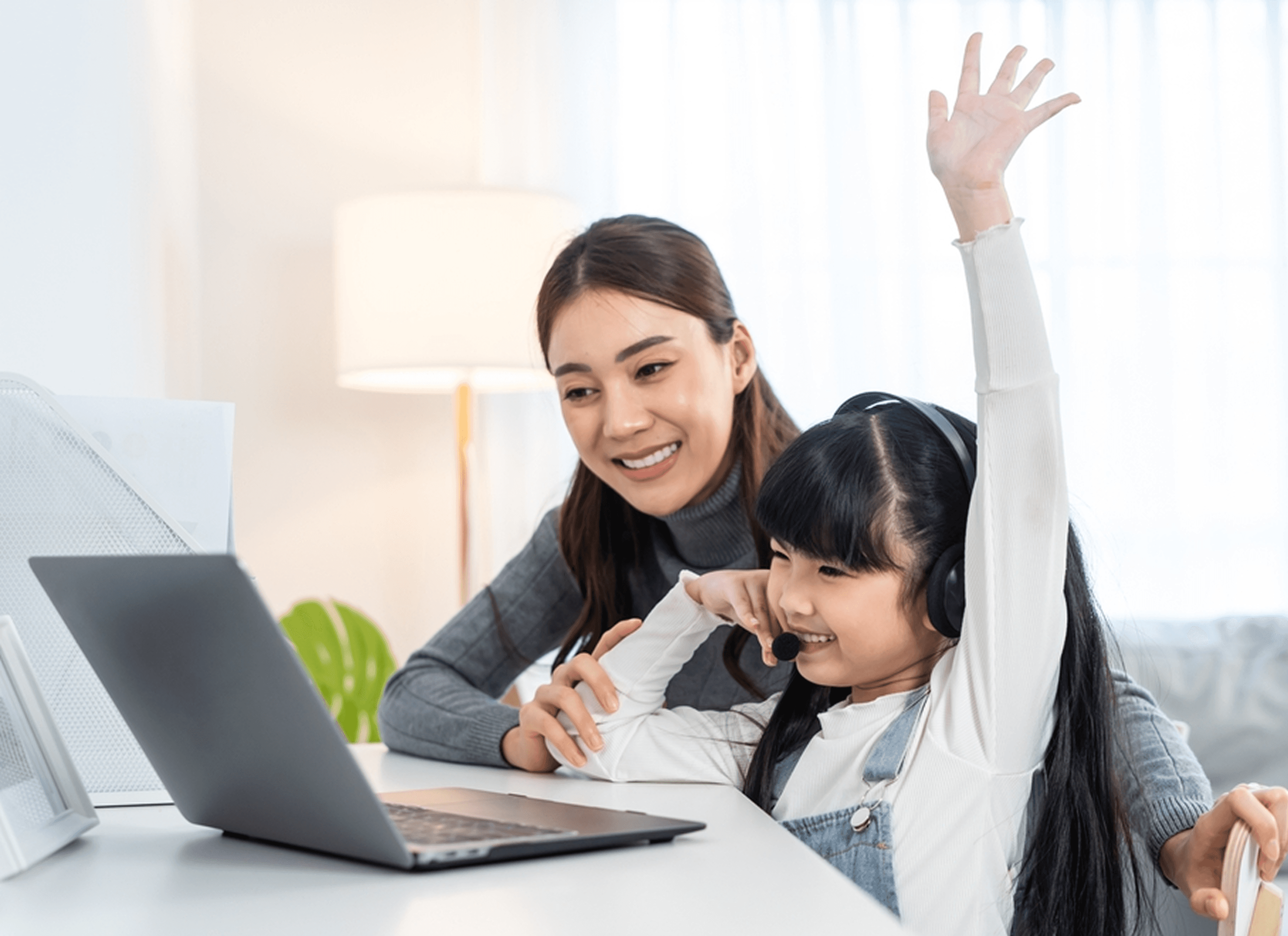 Mother and daughter using laptop